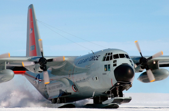 a c-130 outfitted with ski landing gear lands in antarctica