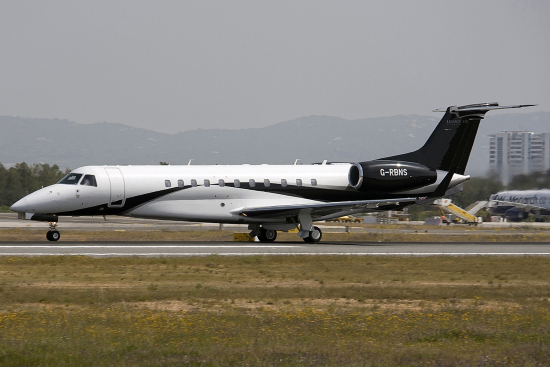 an erj 135 business jet taxis at faro airport in portugal